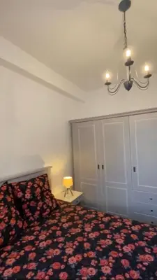 a bedroom with a bed and a chandelier at Appartement entier. Nice Riquier in Nice