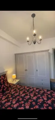a bedroom with a bed and a chandelier at Appartement entier. Nice Riquier in Nice