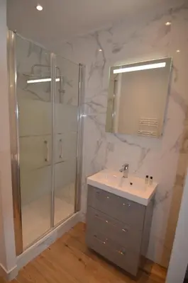 a bathroom with a shower and a sink and a mirror at NAPOLEON - Superbe appartement 2 chambres au cœur du Port de Nice in Nice