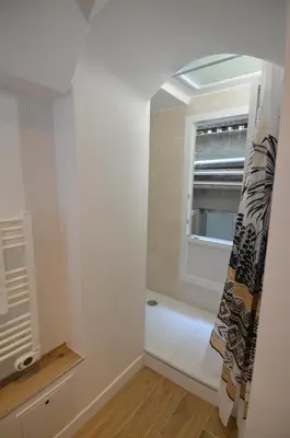 a bathroom with a bath tub and a window at NAPOLEON - Superbe appartement 2 chambres au cœur du Port de Nice in Nice