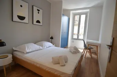 a white bedroom with a bed and a window at NAPOLEON - Superbe appartement 2 chambres au cœur du Port de Nice in Nice