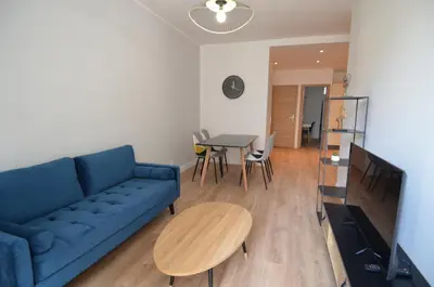 a living room with a blue couch and a table at NAPOLEON - Superbe appartement 2 chambres au cœur du Port de Nice in Nice