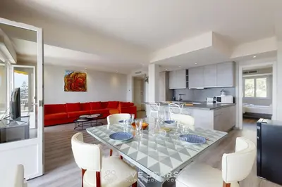 a kitchen and living room with a table and chairs at Suite Horizon FSHH in Beaulieu-sur-Mer