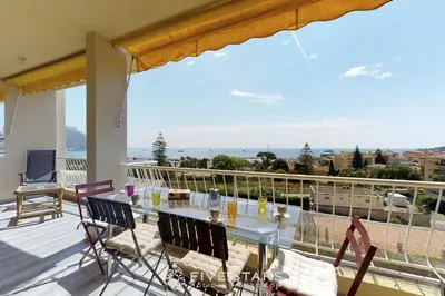 a view from the balcony of a house with a table and chairs at Suite Horizon FSHH in Beaulieu-sur-Mer