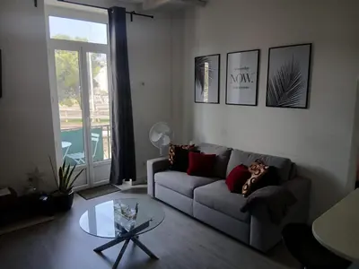 a living room with a couch and a glass table at Bel appartement pour vos séjours sur la côte in Nice