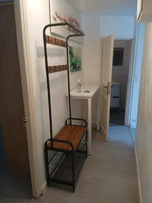 a room with a shelf with a desk and a chair at Bel appartement pour vos séjours sur la côte in Nice
