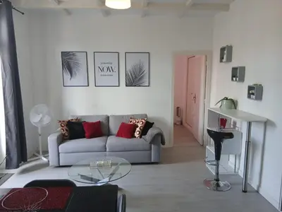 a living room with a couch and a table at Bel appartement pour vos séjours sur la côte in Nice