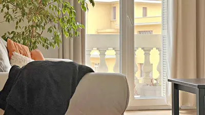 a living room with a couch and a window at LE RIQUIER - Port Lympia à 10 mins à pied in Nice