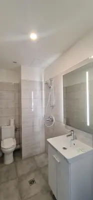 a bathroom with a toilet and a sink and a shower at ESPERANCE HOTEL in Nice