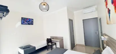 a white room with a bed and a desk in it at ESPERANCE HOTEL in Nice