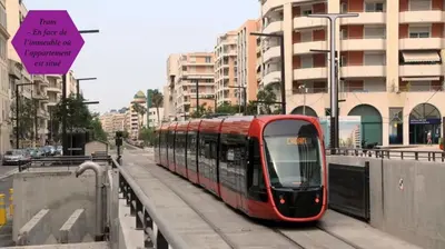 a red tram on a city street with buildings at Studio - 1 minute de la plage et de la Promenade des Anglais in Nice