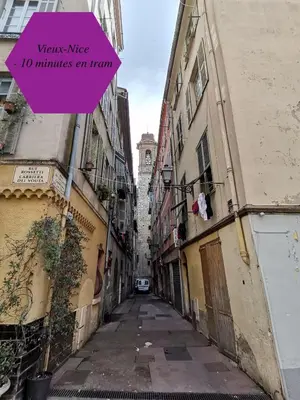 a narrow alley with a pink sign on it at Studio - 1 minute de la plage et de la Promenade des Anglais in Nice