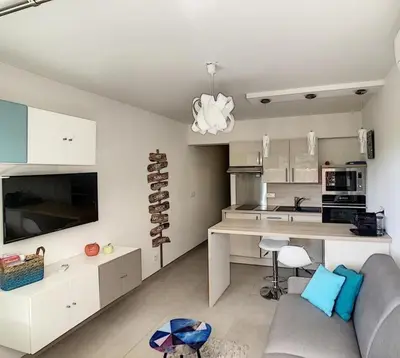 a living room with a couch and a kitchen at Studio - 1 minute de la plage et de la Promenade des Anglais in Nice