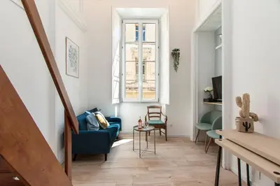 a living room with a blue couch and a window at Maison Bianchi - Prefecture - Old Town in Nice