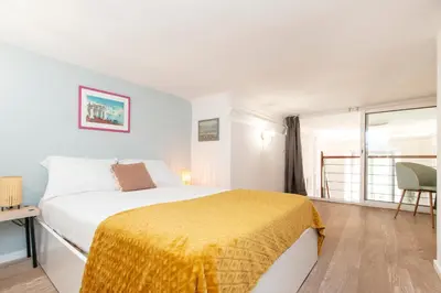 a bedroom with a bed with a yellow blanket on it at Maison Bianchi - Prefecture - Old Town in Nice
