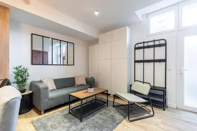 a living room with a couch and a table at Loft Magnan - PARKING - idéal couples -BEACH -TRAM & Supermarkets - New & Confort-AC in Nice