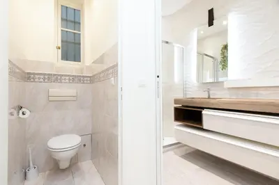 a white bathroom with a toilet and a sink at Maison Bianchi - Victor Hugo in Nice