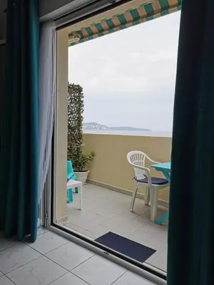 a balcony with a view of a table and chairs at Studio Le Grand Bleu Fshh in Nice