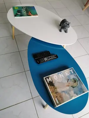 a table with a remote control and a magazine on it at Studio Le Grand Bleu Fshh in Nice