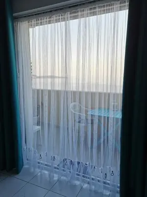 a window with white curtains and a table in a room at Studio Le Grand Bleu Fshh in Nice