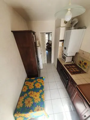 a kitchen with a sink and a stove top oven at Appartement F3 traversant avec 2 terrasses et parking in Cagnes-sur-Mer