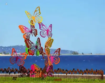 a group of butterflies sitting on the grass near the water at Appartement F3 traversant avec 2 terrasses et parking in Cagnes-sur-Mer