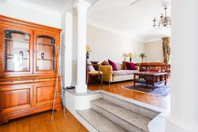 a living room with a large wooden cabinet at LUNG ARNO AP4300 By Riviera Holiday Homes in Nice