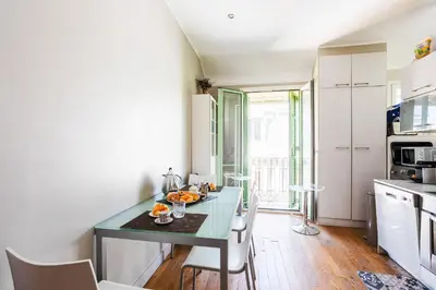 a kitchen with a table and chairs in a room at LUNG ARNO AP4300 By Riviera Holiday Homes in Nice