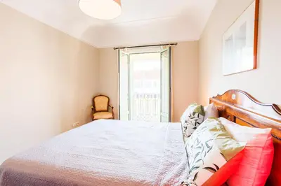 a bedroom with a bed and a window at LUNG ARNO AP4300 By Riviera Holiday Homes in Nice