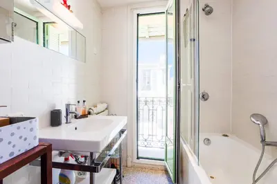 a white bathroom with a sink and a shower at LUNG ARNO AP4300 By Riviera Holiday Homes in Nice