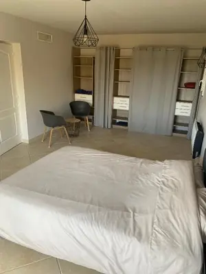 a bedroom with a large white bed in a room at Spacieuse Villa Niçoise au calme avec piscine in Nice