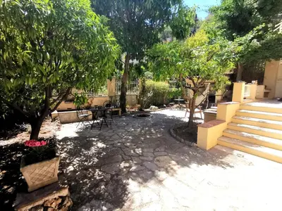 a patio with trees and a table and chairs at Appartement, 3 pièces, Villa Monte Europa in Nice