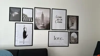 a wall with a bunch of pictures on it at Новая 3-комнатная квартира на 2й линии от моря. in Nice