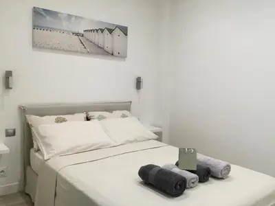 a bedroom with a bed with two towels on it at Carré d’Or super 2 pièces in Nice