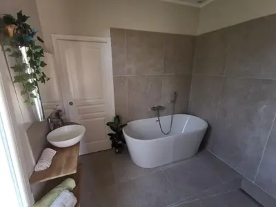 a bathroom with a white tub and a sink at Chambre privée luxueuse Villa Monte 0ropa in Nice