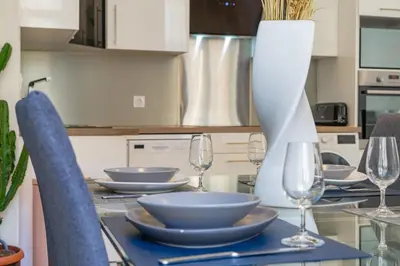 a kitchen with a table with plates and wine glasses at Nice: hyper centre !Super appartement cosy in Nice