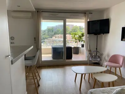 a small living room with a view of a balcony at Nice Absea Fabron 1 in Nice