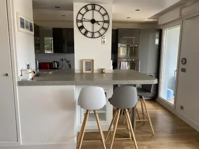 a kitchen with a large clock on the wall at Nice Absea Fabron 1 in Nice