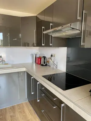 a kitchen with stainless steel appliances and a black counter top at Nice Absea Fabron 1 in Nice