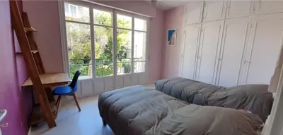 a room with a couch and a chair and a window at SoNiceRiviera in Nice