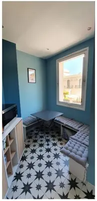 a room with blue walls and a window and a bench at SoNiceRiviera in Nice