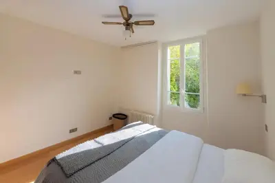 a bedroom with a bed and a ceiling fan at Stunning Beaulieu Sur mer Retreat Chic with Air-Conditioning and Breathtaking Views in Beaulieu-sur-Mer