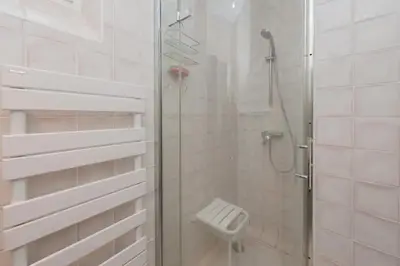 a bathroom with a shower with a glass door at Stunning Beaulieu Sur mer Retreat Chic with Air-Conditioning and Breathtaking Views in Beaulieu-sur-Mer