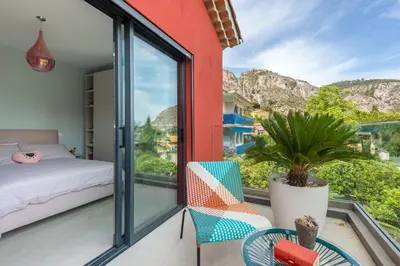 a bedroom with a balcony with a bed and a plant at Deluxe VILLA GRAZIELLA 200 M FROM THE BEACH in Èze