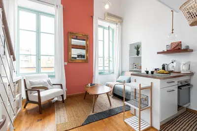 a kitchen and living room with orange and white walls at Plage et Shopping ! Appartement au cœur de Nice ! in Nice