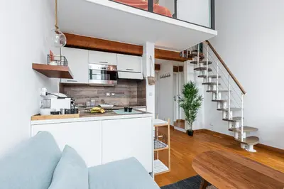 a kitchen and a living room with a spiral staircase at Plage et Shopping ! Appartement au cœur de Nice ! in Nice