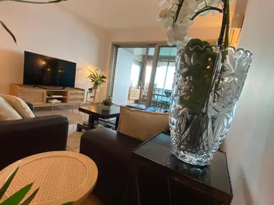 a vase with flowers on a table in a living room at LE BAHIA in Nice