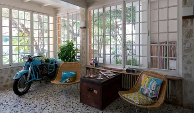 a room with a scooter parked in a room with windows at Le Val Duchesse Hotel & Appartements in Cagnes-sur-Mer
