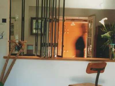 a shelf with books and a chair in a room at Le Val Duchesse Hotel & Appartements in Cagnes-sur-Mer