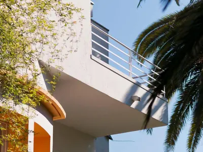 a building with a balcony on the side of it at Le Val Duchesse Hotel & Appartements in Cagnes-sur-Mer